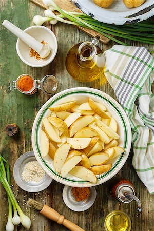 simsearch:400-06701002,k - Raw potatoes in a deep plate, sliced for roasting in the oven Stock Photo - Budget Royalty-Free & Subscription, Code: 400-09097150