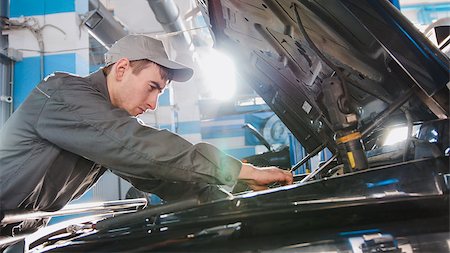 Mechanic male in automobile garage checking hood of the car for luxury SUV, close up Stock Photo - Budget Royalty-Free & Subscription, Code: 400-09091312