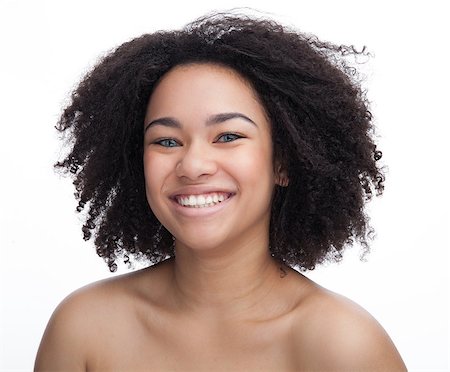 Portrait of a smiling young african girl, Isolated over white background Stock Photo - Budget Royalty-Free & Subscription, Code: 400-09092116