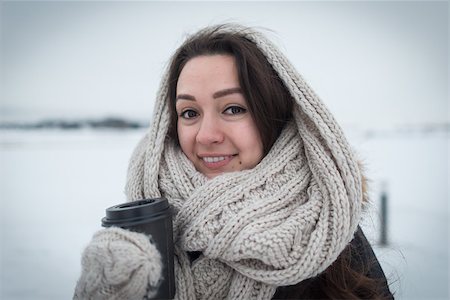 snow cosy - Young woman in warm and soft scarf with hot coffee in cup for take away staying at clear field on the winter background. Cold day. White and soft colors. Stock Photo - Budget Royalty-Free & Subscription, Code: 400-09093267