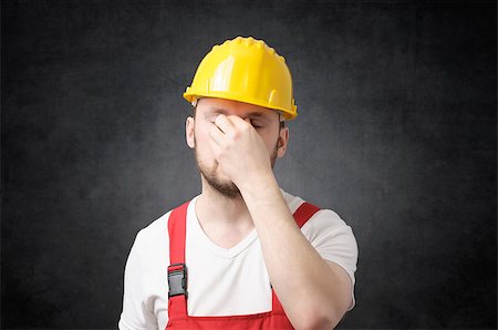 simsearch:400-06953077,k - Tired construction worker in yellow hard hat, covering his face Stock Photo - Budget Royalty-Free & Subscription, Code: 400-09119594