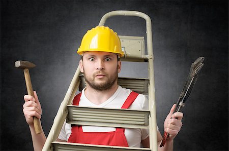 Clumsy worker with ladder, hammer and pipe wrench Stock Photo - Budget Royalty-Free & Subscription, Code: 400-09119682