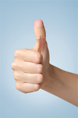 simsearch:400-07831838,k - Female thumb with adhesive bandage on blue background Foto de stock - Royalty-Free Super Valor e Assinatura, Número: 400-09119762