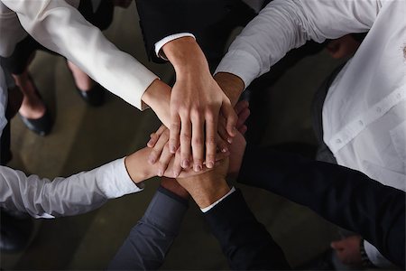 simsearch:400-04390114,k - Business people joining hands in a circle in the office. concept of teamwork and partnership Photographie de stock - Aubaine LD & Abonnement, Code: 400-09112289