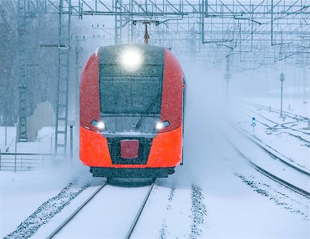 Highspeed train approaches to the station platform at snowstormy day time. Stock Photo - Budget Royalty-Free & Subscription, Code: 400-09112594