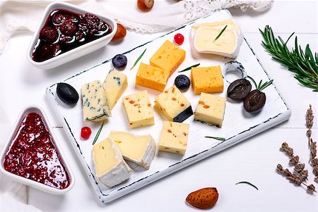 simsearch:400-05682309,k - square pieces of camembert cheese, roquefort, cheddar and brie on a white wooden board, next to a raspberry and strawberry jam, top view Stock Photo - Budget Royalty-Free & Subscription, Code: 400-09120019
