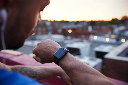 Male urban runner checks fitness app on smartwatch, close up Stock Photo - Budget Royalty-Free & Subscription, Code: 400-09121832