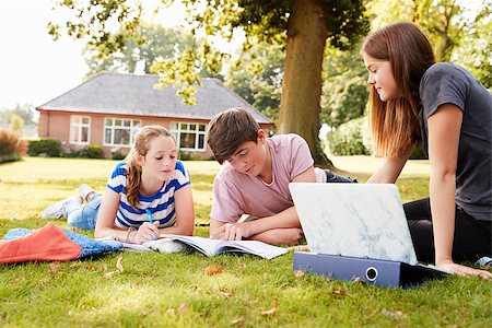 Teenage Students Sitting Outdoors And Working On Project Stock Photo - Budget Royalty-Free & Subscription, Code: 400-09121949