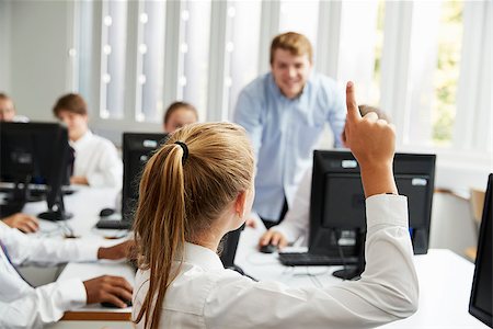 simsearch:400-09121991,k - Teenage Students Asking Teacher Question In IT Class Fotografie stock - Microstock e Abbonamento, Codice: 400-09121964