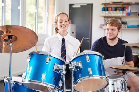 simsearch:400-09121991,k - Female Pupil With Teacher Playing Drums In Music Lesson Fotografie stock - Microstock e Abbonamento, Codice: 400-09121980