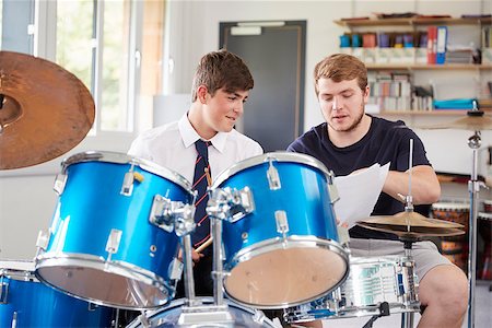 simsearch:400-09121964,k - Male Pupil With Teacher Playing Drums In Music Lesson Stock Photo - Budget Royalty-Free & Subscription, Code: 400-09121981