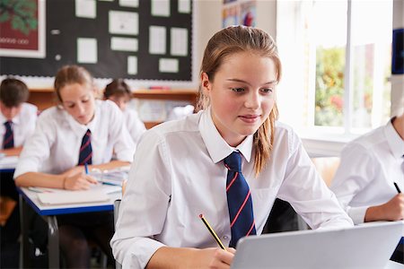simsearch:400-09121964,k - Female Pupil Wearing Uniform Using Laptop In Classroom Stock Photo - Budget Royalty-Free & Subscription, Code: 400-09122014
