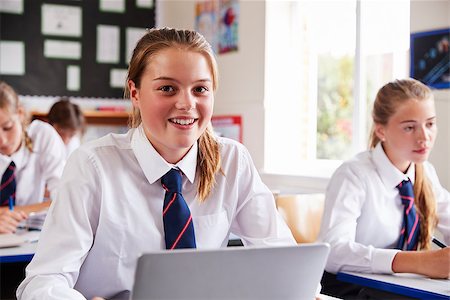 simsearch:400-09121991,k - Portrait Of Female Pupil In Uniform Using Laptop In Classroom Fotografie stock - Microstock e Abbonamento, Codice: 400-09122011