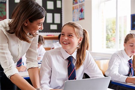 simsearch:400-09121964,k - Female Teacher Helping Pupil Using Computer In Classroom Stock Photo - Budget Royalty-Free & Subscription, Code: 400-09122012