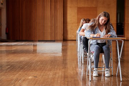 Group Of Teenage Students Sitting Examination In School Hall Stock Photo - Budget Royalty-Free & Subscription, Code: 400-09122088