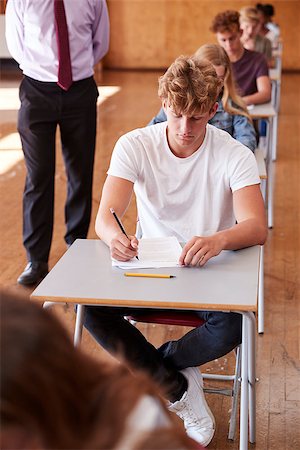 Teenage Students Sitting Examination With Teacher Invigilating Stock Photo - Budget Royalty-Free & Subscription, Code: 400-09122095