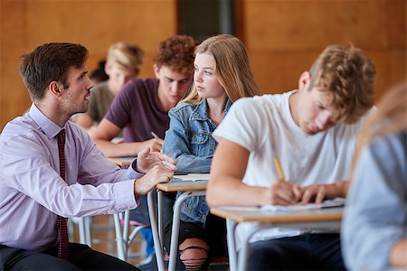 Teenage Students Sitting Examination With Teacher Invigilating Stock Photo - Budget Royalty-Free & Subscription, Code: 400-09122096