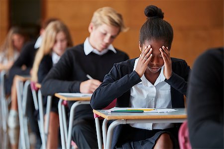 Anxious Teenage Student Sitting Examination In School Hall Stock Photo - Budget Royalty-Free & Subscription, Code: 400-09122099