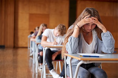 Anxious Teenage Student Sitting Examination In School Hall Stock Photo - Budget Royalty-Free & Subscription, Code: 400-09122090