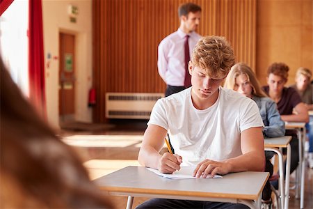 Teenage Students Sitting Examination With Teacher Invigilating Stock Photo - Budget Royalty-Free & Subscription, Code: 400-09122091