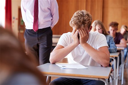 Anxious Teenage Student Sitting Examination In School Hall Stock Photo - Budget Royalty-Free & Subscription, Code: 400-09122092