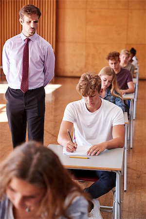 Teenage Students Sitting Examination With Teacher Invigilating Stock Photo - Budget Royalty-Free & Subscription, Code: 400-09122093