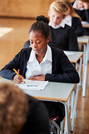 Teenage Students In Uniform Sitting Examination In School Hall Stock Photo - Budget Royalty-Free & Subscription, Code: 400-09122103