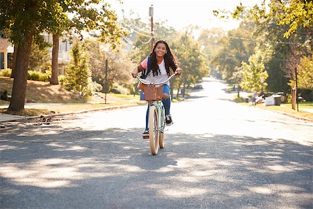 Girl Riding Bike Along Street To School Stock Photo - Budget Royalty-Free & Subscription, Code: 400-09122170