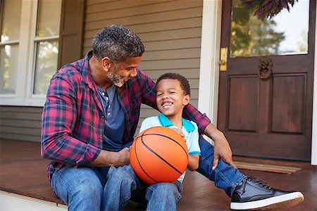 Father And Son Discussing Basketball On Porch Of Home Stock Photo - Budget Royalty-Free & Subscription, Code: 400-09122200