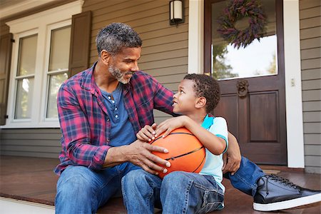 Father And Son Discussing Basketball On Porch Of Home Stock Photo - Budget Royalty-Free & Subscription, Code: 400-09122201