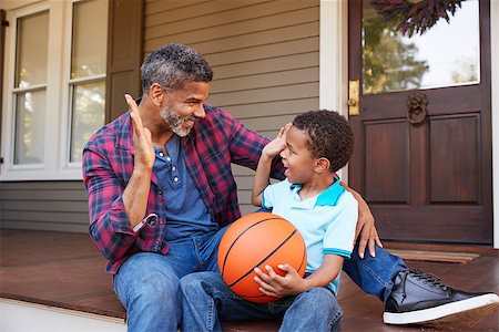 Father And Son Discussing Basketball On Porch Of Home Stock Photo - Budget Royalty-Free & Subscription, Code: 400-09122202