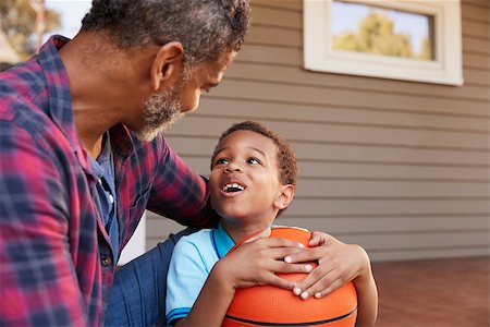 Father And Son Discussing Basketball On Porch Of Home Stock Photo - Budget Royalty-Free & Subscription, Code: 400-09122203
