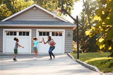 Mother And Children Playing Basketball On Driveway At Home Stock Photo - Budget Royalty-Free & Subscription, Code: 400-09122264