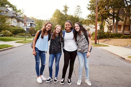 Teen girls on the way to school look to camera, full length Stock Photo - Budget Royalty-Free & Subscription, Code: 400-09122440