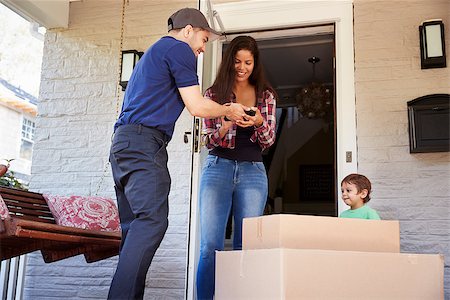 Courier Asking Woman To Confirm Delivery On Digital Tablet Stock Photo - Budget Royalty-Free & Subscription, Code: 400-09122465