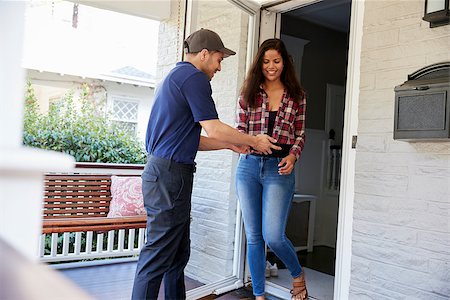 Courier Asking Woman To Confirm Delivery On Digital Tablet Stock Photo - Budget Royalty-Free & Subscription, Code: 400-09122468