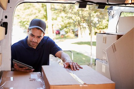 Courier With Digital Tablet Checking Packages In Van Stock Photo - Budget Royalty-Free & Subscription, Code: 400-09122472