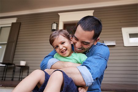 quartiere latino - Father Hugging Son As They Sit On Porch Of House Together Photographie de stock - Aubaine LD & Abonnement, Code: 400-09122536