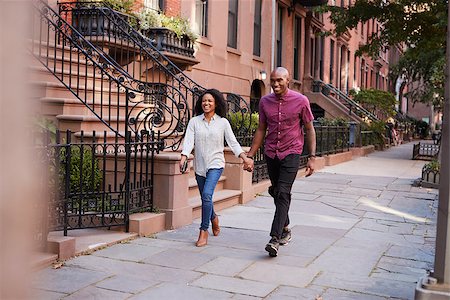 Young Couple Walking Along Urban Street In New York City Stock Photo - Budget Royalty-Free & Subscription, Code: 400-09122651