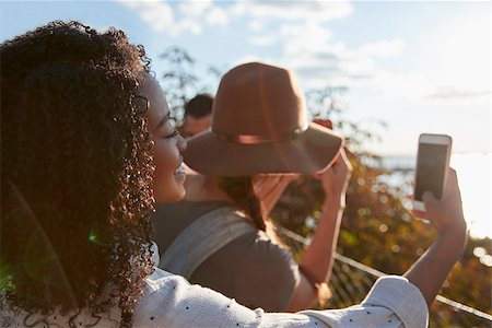 Group Of Tourists Taking Photos On Mobile Phones Stock Photo - Budget Royalty-Free & Subscription, Code: 400-09122685