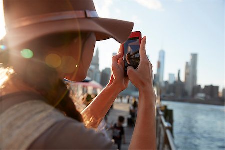Tourist Taking Photo Of Manhattan Skyline On Mobile Phone Stock Photo - Budget Royalty-Free & Subscription, Code: 400-09122689