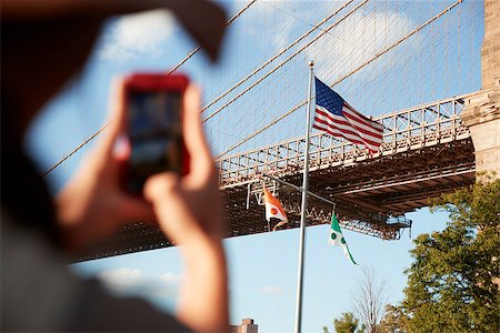 Tourist Taking Photo Of Brooklyn Bridge On Mobile Phone Stock Photo - Budget Royalty-Free & Subscription, Code: 400-09122691