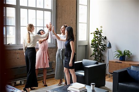 Female colleagues high five at a motivational meeting Stock Photo - Budget Royalty-Free & Subscription, Code: 400-09122760