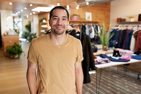 simsearch:862-06541089,k - Smiling young Hispanic man standing in a clothes shop Stock Photo - Budget Royalty-Free & Subscription, Code: 400-09122920