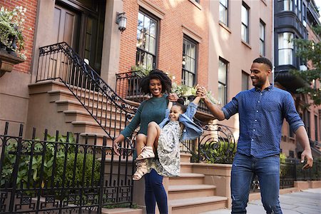 Family taking a walk down the street, close up Stock Photo - Budget Royalty-Free & Subscription, Code: 400-09123158