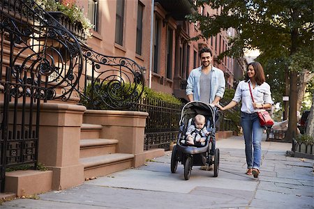 Family taking a walk down the street, close up Stock Photo - Budget Royalty-Free & Subscription, Code: 400-09123150