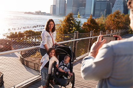 simsearch:400-09123158,k - Young family with two daughters taking a photo on footbridge Foto de stock - Royalty-Free Super Valor e Assinatura, Número: 400-09123183