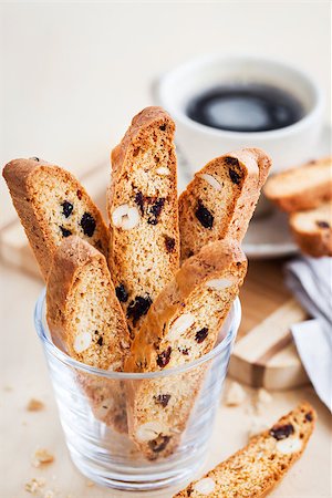 Italian cranberry almond biscotti  and cup of coffee on background Stock Photo - Budget Royalty-Free & Subscription, Code: 400-09131915