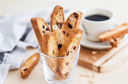 Italian cranberry almond biscotti  and cup of coffee on background Stock Photo - Budget Royalty-Free & Subscription, Code: 400-09131916