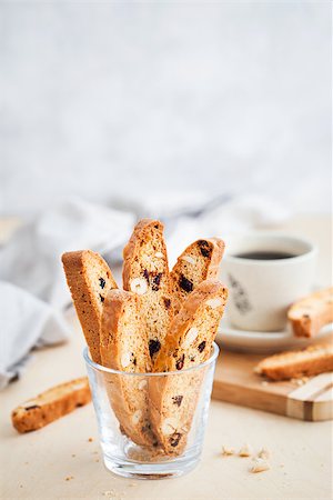 Italian cranberry almond biscotti  and cup of coffee on background Stock Photo - Budget Royalty-Free & Subscription, Code: 400-09131917